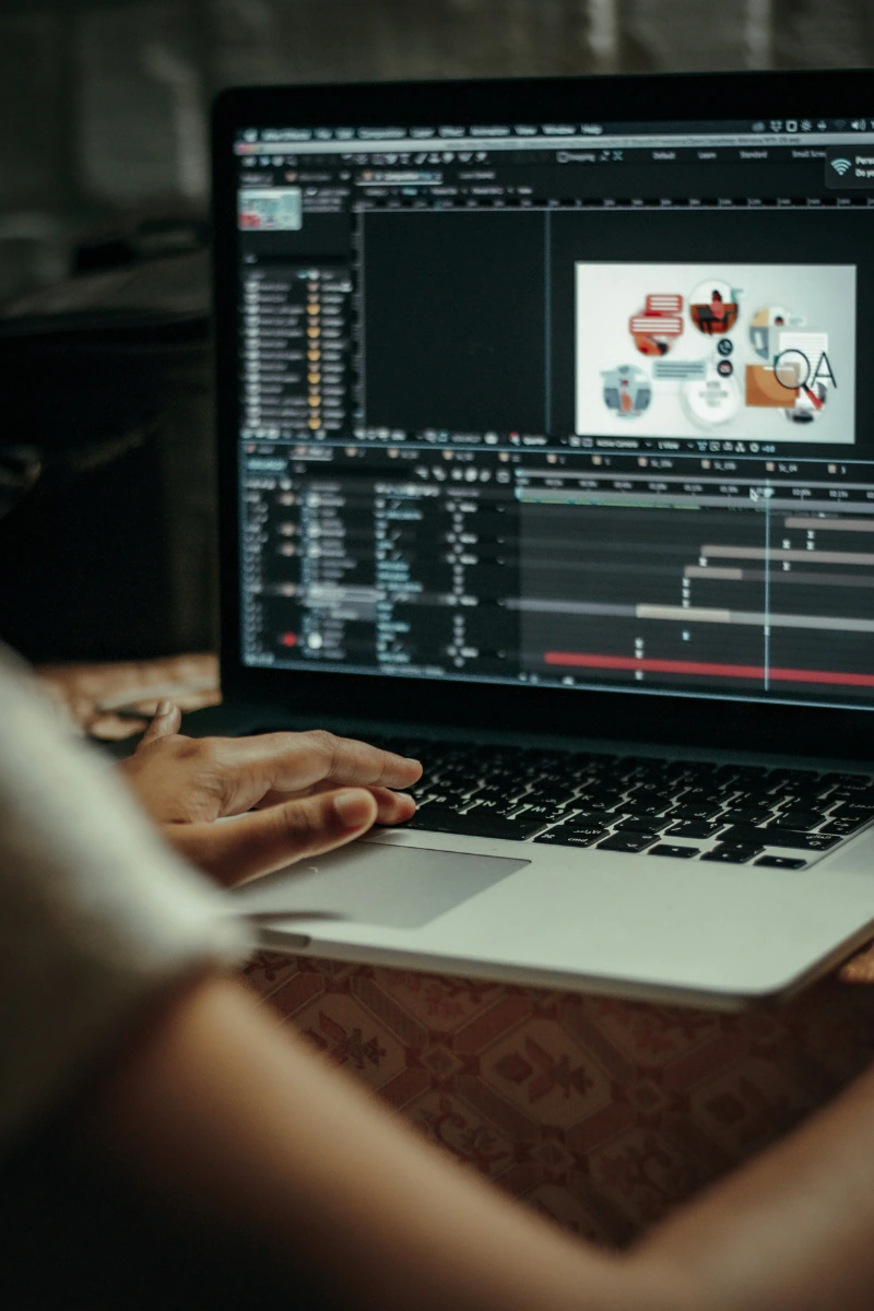 person-working-on-laptop-with-video-editing-software-showing-timeline-and-graphics-on-screen