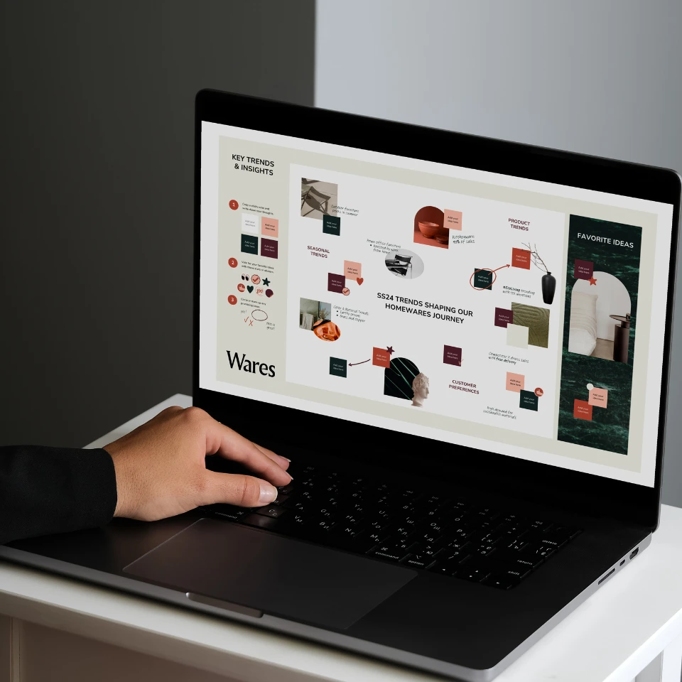 Person interacting with a laptop displaying a visual presentation of 2024 homeware trends and design insights, featuring color swatches and product ideas.